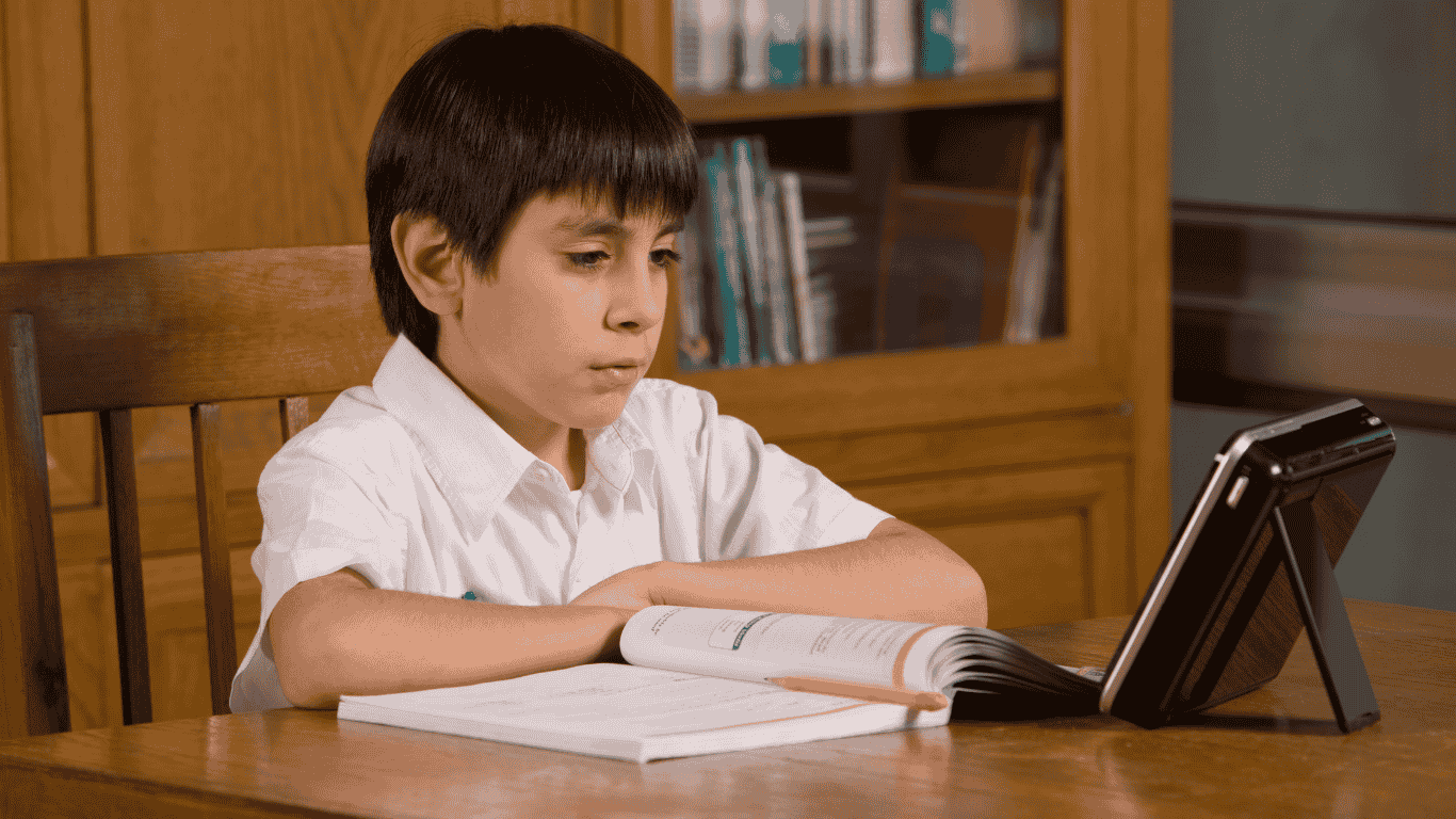 A young boy attending Online school class from his home